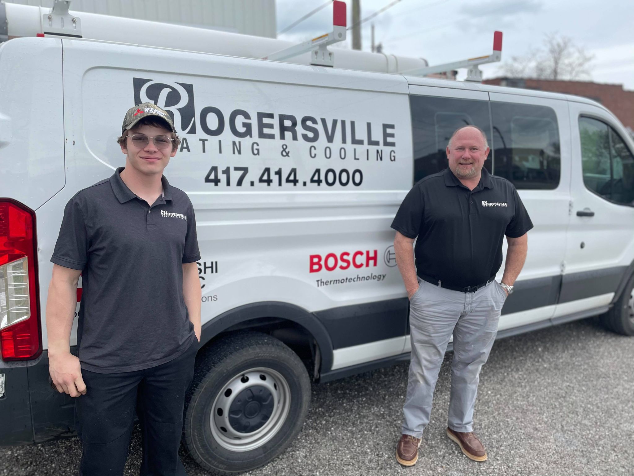 Keagan and Patrick of Rogersville Heating & Cooling, standing in front of the service van.